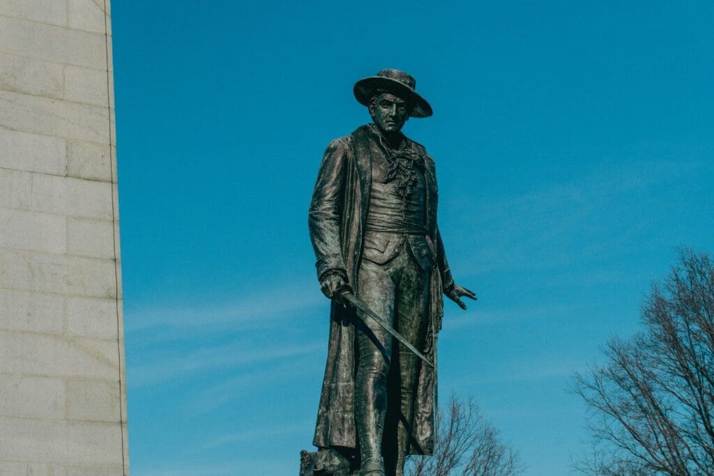 A statue stands tall at the Bunker Hill Monument. 