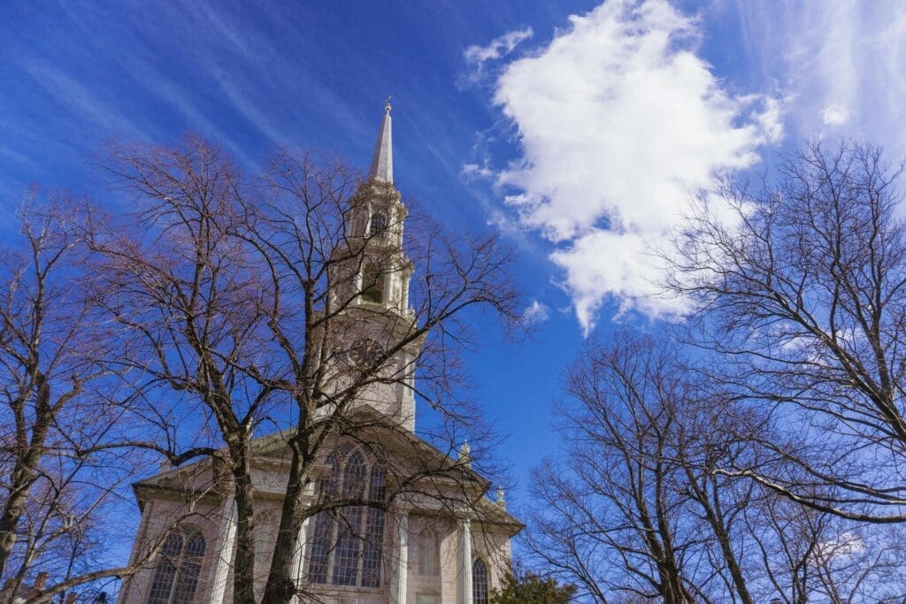 The First Baptist Church of America stands tall on a clear day. It is one of the 15 things to do alone in Rhode Island.