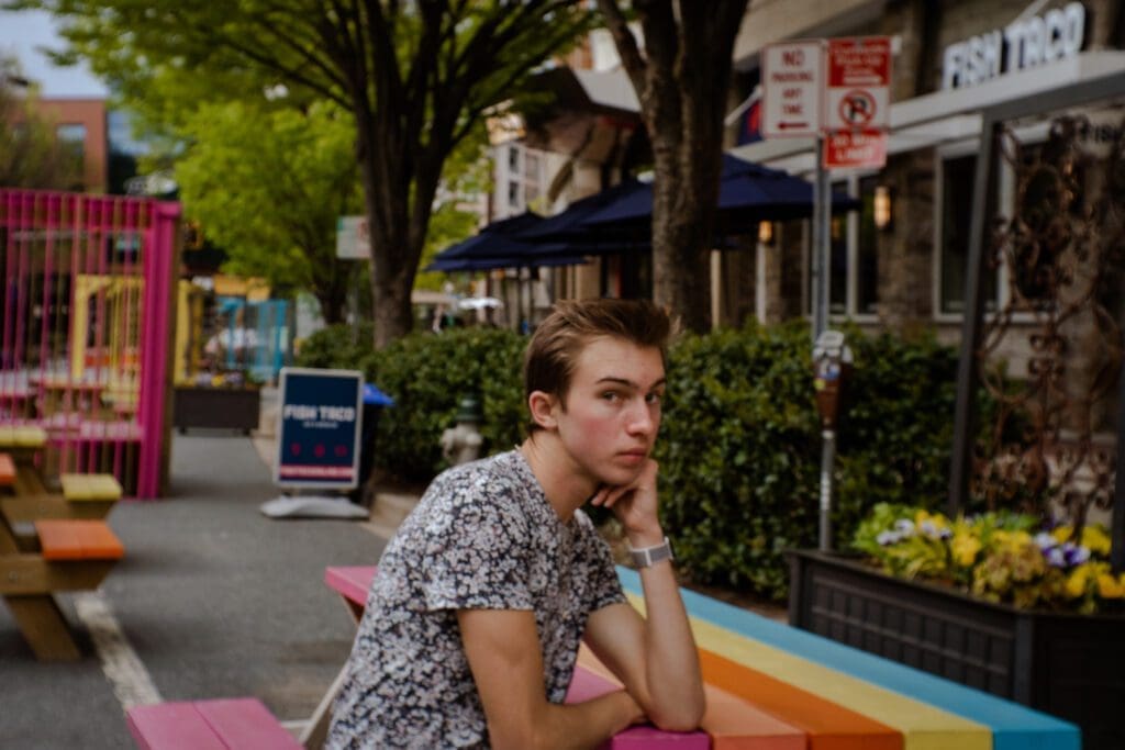 Noah poses during outside of a strip mall for one of the many things to do alone in D.C,