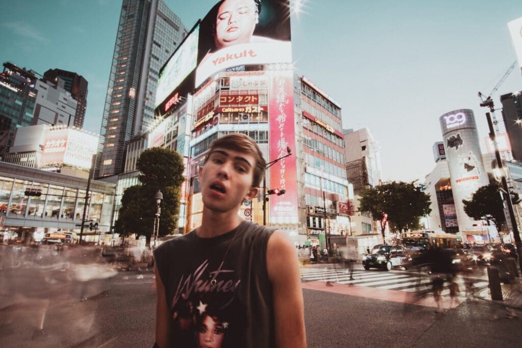 Noah poses infront of the world's most iconic street crossing during his Tokyo solo travel itinerary. 