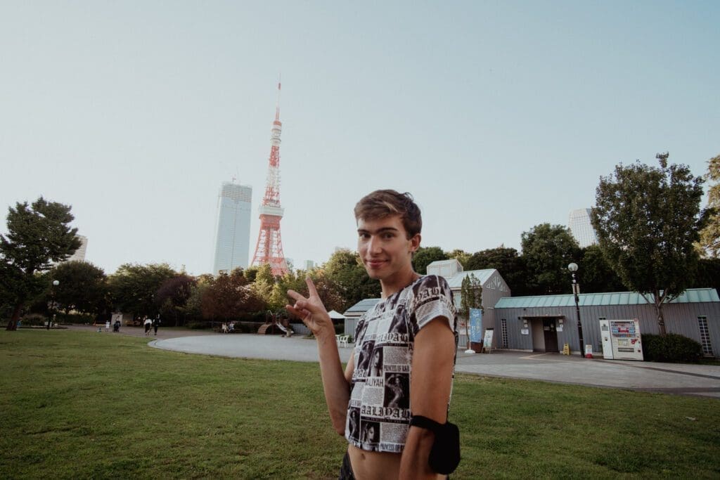 Noah poses behind Tokyo Tower in the background. 