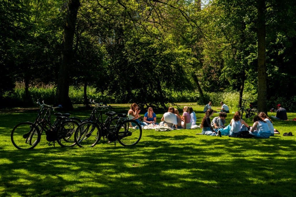 A group of teens picnic in Amsterdam.