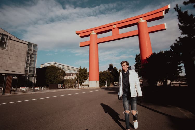 Noah during his Kyoto solo trip walking near the large Otenmon orange torii gate. 