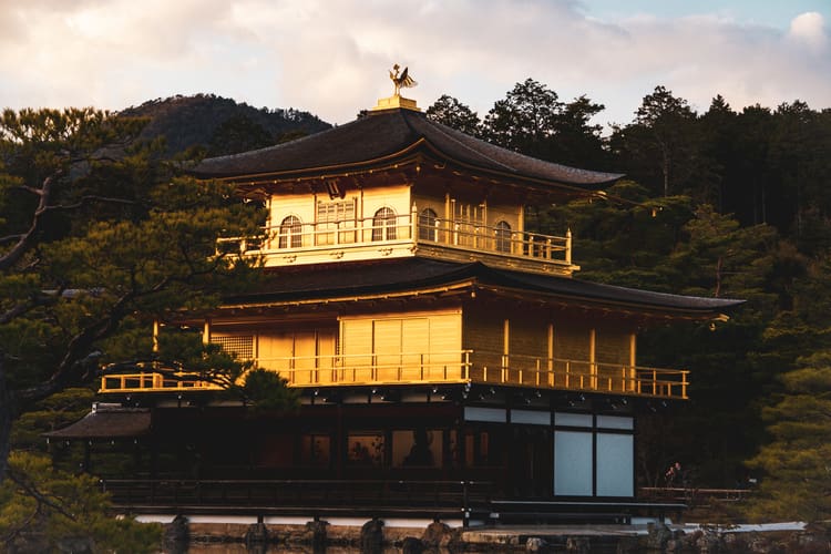 Golden hour light shines on the famous Kinaku-ji temple