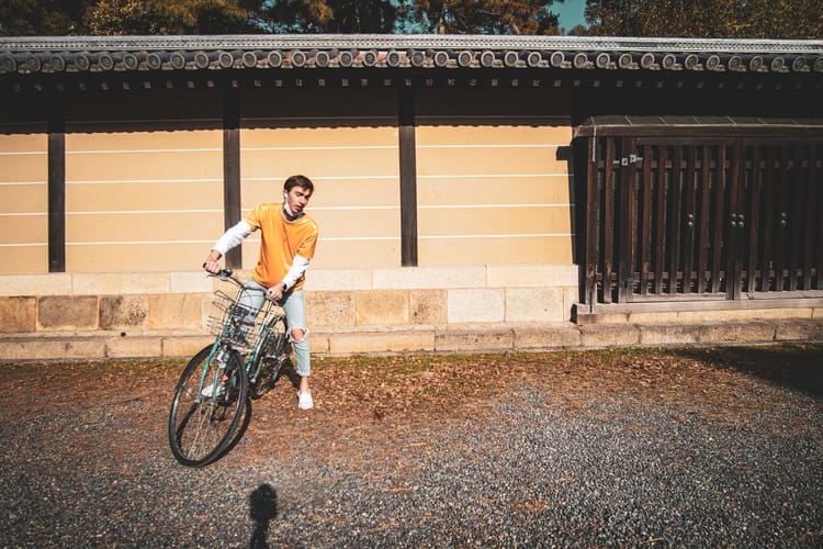 Noah with his bike stands infront of the Kyoto Gyoen during his Kyoto solo trip.