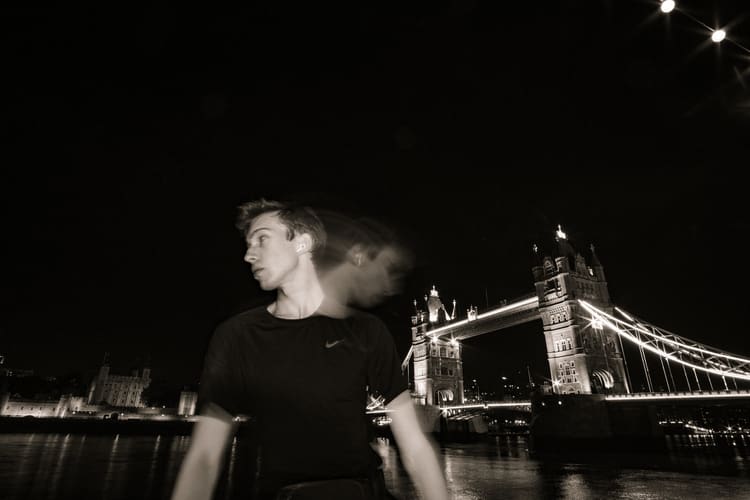 Noah stands in the background of the London Bridge during one of his solo trip to London.